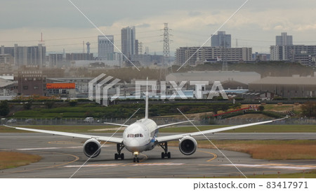 Airplane landing and heading to the tarmac Airplane landing and heading to the tarmac 83417971
