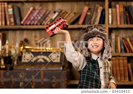 Girl playing with toys Vintage hat pilot Girl playing with toys Vintage hat pilot 83418453