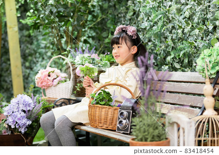 A girl sitting on a bench A girl sitting on a bench 83418454