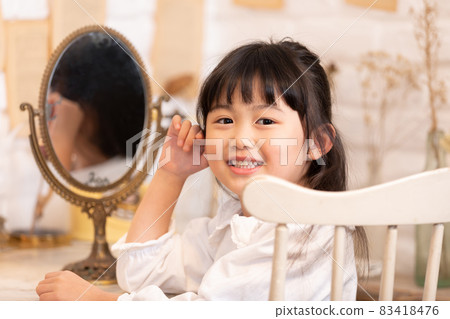 Girl playing in an antique mirror Girl playing in an antique mirror 83418476