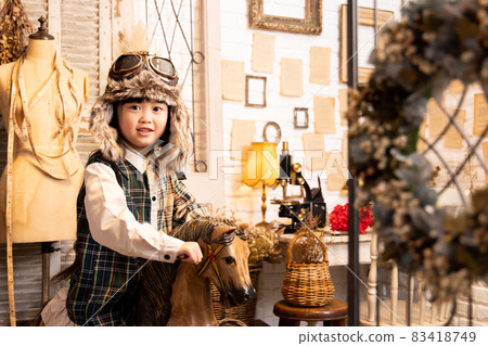 Girl riding an antique wooden horse Girl riding an antique wooden horse 83418749