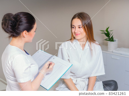 Female Patient And Doctor Have Consultation In medical clinic, writing notes Female Patient And Doctor Have Consultation In medical clinic, writing notes 83421261