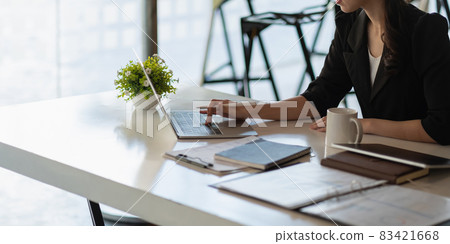 Close up young beautiful asian businesswoman working on laptop in modern office, business finance concept 83421668