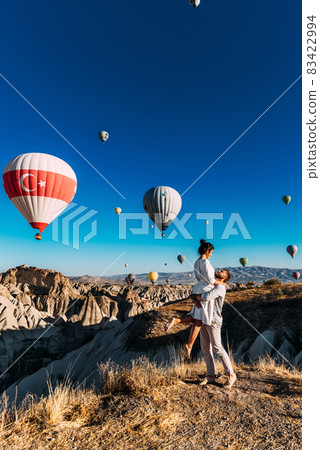 Happy couple in Cappadocia. The man proposed to the girl. Honeymoon in Cappadocia. Couple at the balloon festival. Couple travels the world. The Landscapes Of Cappadocia 83422994