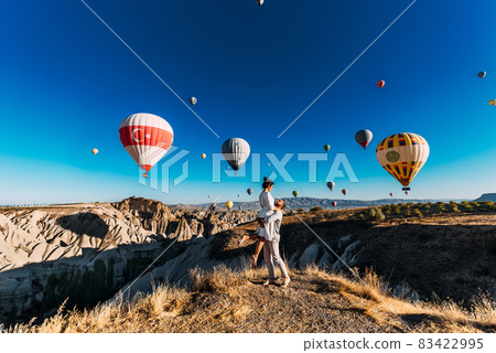 Happy couple in Cappadocia. The man proposed to the girl. Honeymoon in Cappadocia. Couple at the balloon festival. Honeymoon trip. Couple travels the world. The Landscapes Of Cappadocia 83422995