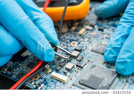 technician repairing inside of hard disk by soldering iron. Integrated Circuit. the concept of data, hardware, technician and technology. 83423558