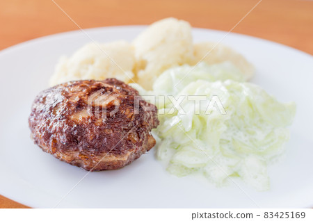Polish kotlet mielony (meatballs) with mizeria and mashed potatoes. 83425169
