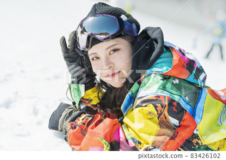 A woman snowboarding A woman snowboarding 83426102