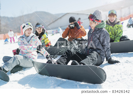 College students playing at the ski resort 83426142