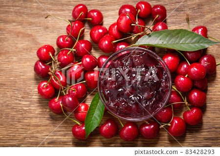 bowl of cherry jam with fresh fruits on a wooden background bowl of cherry jam with fresh fruits on a wooden background 83428293