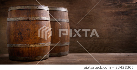 Old wooden barrels in a warehouse 83428305