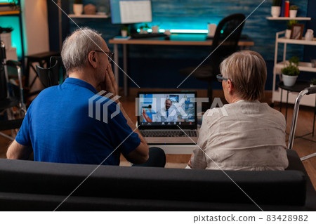 Elder people using video call conference on laptop with dentist Elder people using video call conference on laptop with dentist 83428982