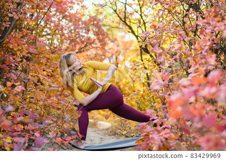 Woman make yoga stretching exercises in forest Woman make yoga stretching exercises in forest 83429969