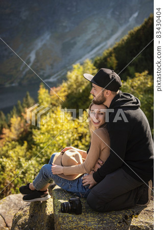 Young tourist couple, man and woman, on hiking path in mountains 83430404