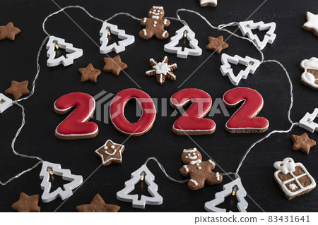 Set of numbers 2022 from ginger biscuits glazed sugar icing. Snowflakes, stars, gingerbread man. Set of numbers 2022 from ginger biscuits glazed sugar icing. Snowflakes, stars, gingerbread man. 83431641