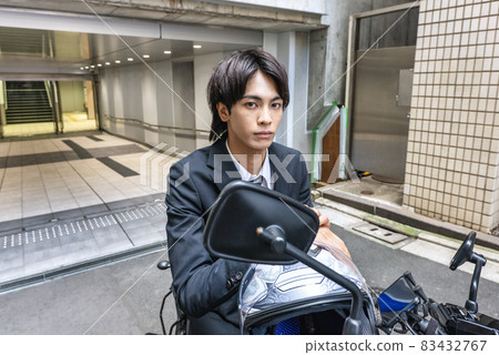 Young businessman and large bike 83432767