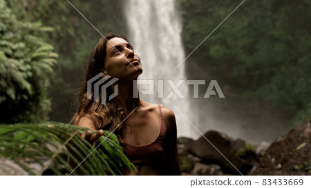 portrait of a women on a background of the jungle. portrait of a women on a background of the jungle. 83433669
