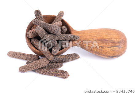 Long pepper in wooden spoon, isolated on white background. Heap of pippali or piper longum. Long pepper in wooden spoon, isolated on white background. Heap of pippali or piper longum. 83433746