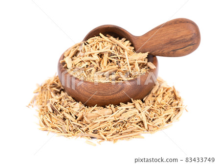 Muira Puama herbal tea in wooden bowl and spoon, isolated on white background. Natural potency wood, medicinal plant, dry tea. Ptychopetalum olacoides. 83433749