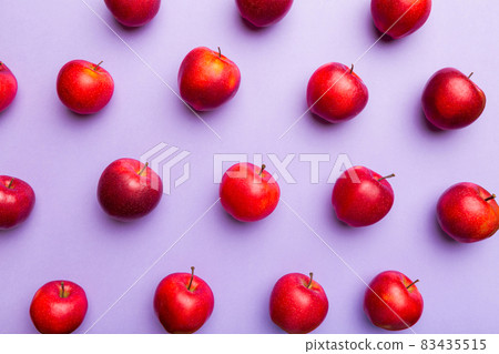 Many red apples on colored background, top view. Autumn pattern with fresh apple above view 83435515