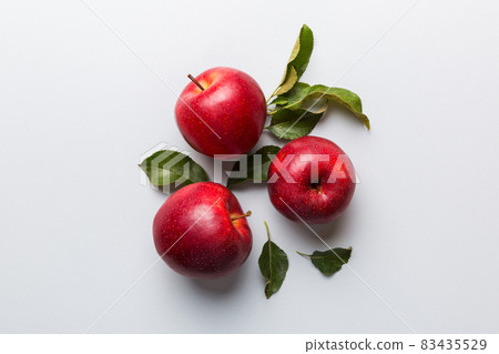 Many red apples on colored background, top view. Autumn pattern with fresh apple above view with copy space for design or text 83435529