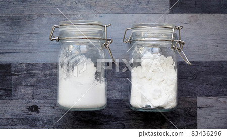 A photo of two white powder seasonings in a fashionable bottle 83436296