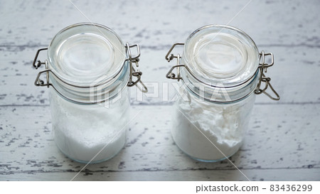 A photo of two white powder seasonings in a fashionable bottle 83436299