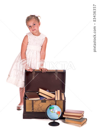 girl and a chest with books. little girl looking inside a trunk with surprise on white background girl and a chest with books. little girl looking inside a trunk with surprise on white background 83436357