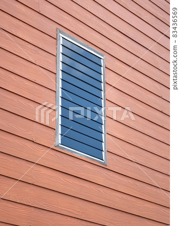 Glass louvered windows on prefabricated wooden planks . Glass louvered windows on prefabricated wooden planks . 83436569