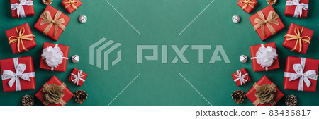 Gift boxes with white and brown bows on a green backdrop. 83436817