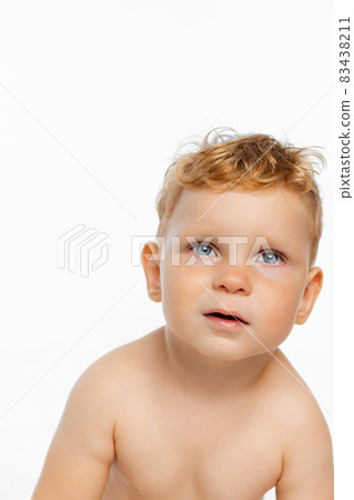 Close-up portrait of cute little boy, child posing isolated over white background 83438211
