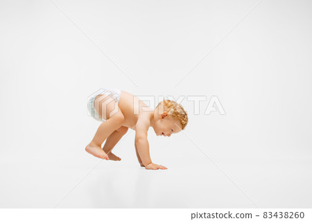 Full-length portrait of little boy, child in diaper standing up isolated over white background Full-length portrait of little boy, child in diaper standing up isolated over white background 83438260
