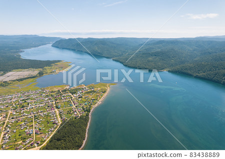 The Angara River is a major river in Siberia leaving Lake Baikal near the settlement of Listvyanka. Panoramic aerial view. The Angara River is a major river in Siberia leaving Lake Baikal near the settlement of Listvyanka. Panoramic aerial view. 83438889