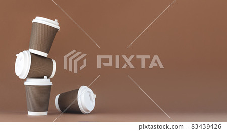 Stack of disposable paper coffee cup with cap 83439426
