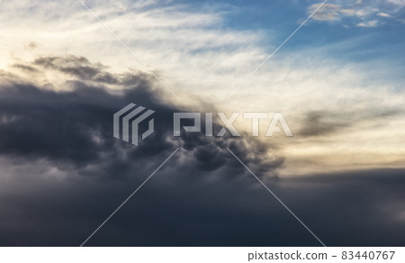 View of dark cloudscape during dramatic sunset on the ocean coast 83440767