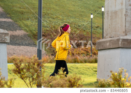 young woman jogging in the park under an overpass young woman jogging in the park under an overpass 83440805