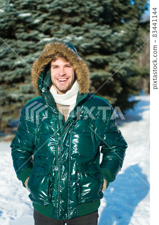 Winter outfit. Man unshaven wear warm jacket with fur 83441144