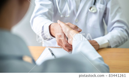 Male doctor shaking hands with female patient to congratulation after the treatment method successful Male doctor shaking hands with female patient to congratulation after the treatment method successful 83441261