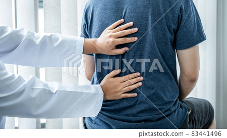 Female physiotherapist is checking spine of patient to doing healing treatment and rehabilitation injured back 83441496