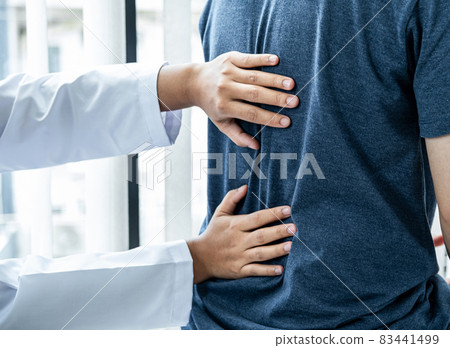Female physiotherapist is checking spine of patient to doing healing treatment and rehabilitation injured back Female physiotherapist is checking spine of patient to doing healing treatment and rehabilitation injured back 83441499