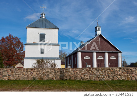 Old ancient wooden church of St Michael the Archangel and bell tower in Netech village, Lida district, Grodno region, Belarus. Old ancient wooden church of St Michael the Archangel and bell tower in Netech village, Lida district, Grodno region, Belarus. 83441555