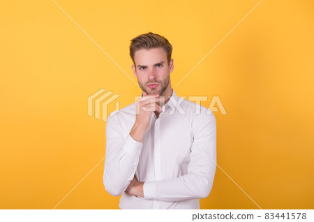 confident unshaven guy in white shirt has groomed hair, male beauty 83441578