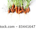 carrots with soil and green leaves on white 83441647