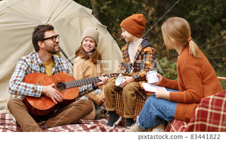 Happy parents and kids enjoying great family camping trip in nature Happy parents and kids enjoying great family camping trip in nature 83441822