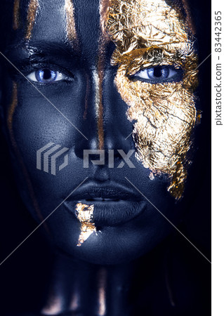 fashion portrait of a blue-skinned girl with gold make-up. Beauty face. 83442365