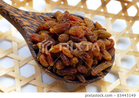 Dried grape raisins in wooden spoon Dried grape raisins in wooden spoon 83443149