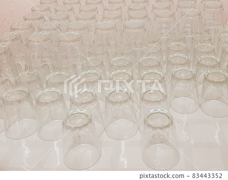 Lots of clean empty glass drinks glasses on the table, service in the hotel cafe Lots of clean empty glass drinks glasses on the table, service in the hotel cafe 83443352
