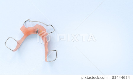 removable orthodontic appliance on Blue. Concept of healthy teeth.  83444654