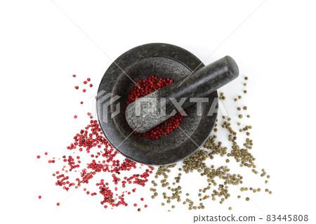 Top view of pink and green peppercorns with mortar and pestle isolated on white Top view of pink and green peppercorns with mortar and pestle isolated on white 83445808