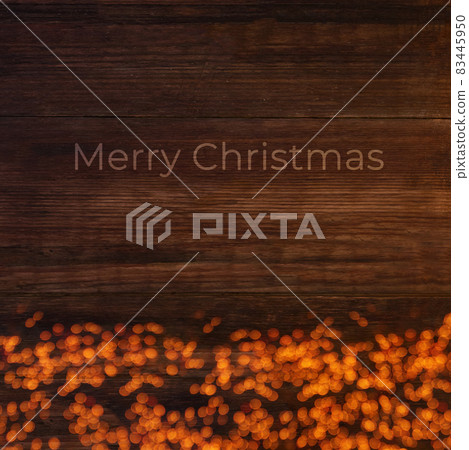 Lights on a wooden brown background with text Merry Christmas, Christmas card 83445950